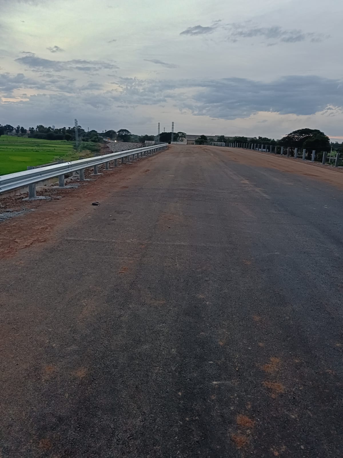 Metal beam crash barrier